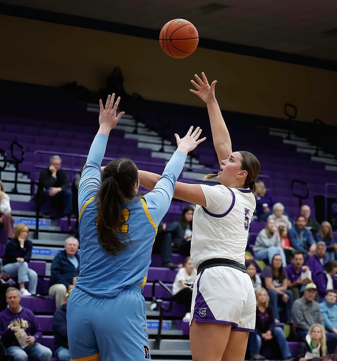 Fighting Saints senior, Meagan Karstetter, takes a hook shot during a game last season. Karstetter said she loves to play in the post and finds it to be uncommon nowadays among other players at her position.