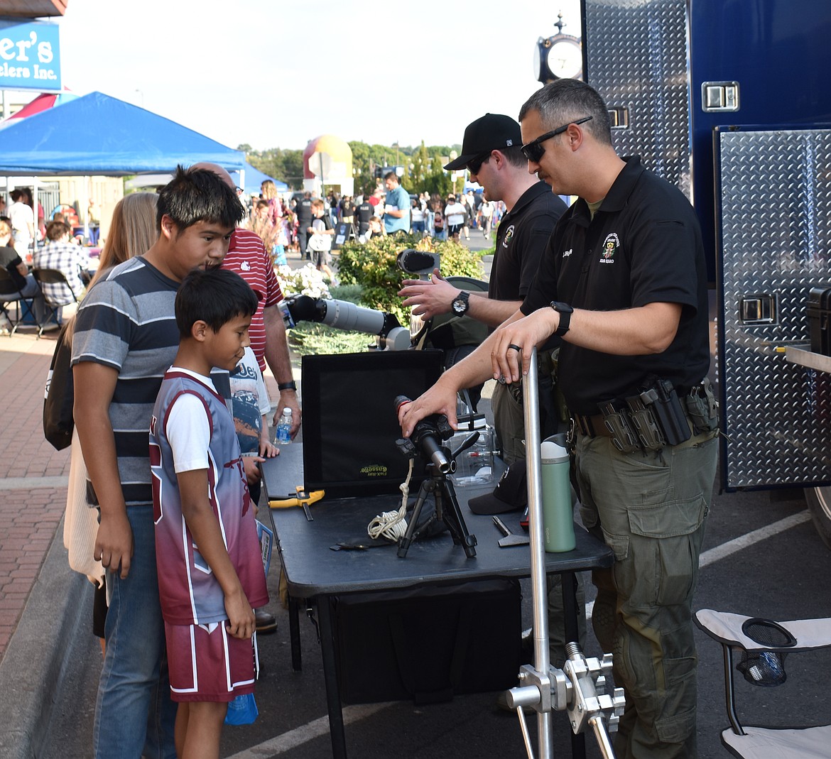 A young attendee at Quincy’s National Night Out suffers the consequences of a well-placed pitch to the dunk tower Monday.
