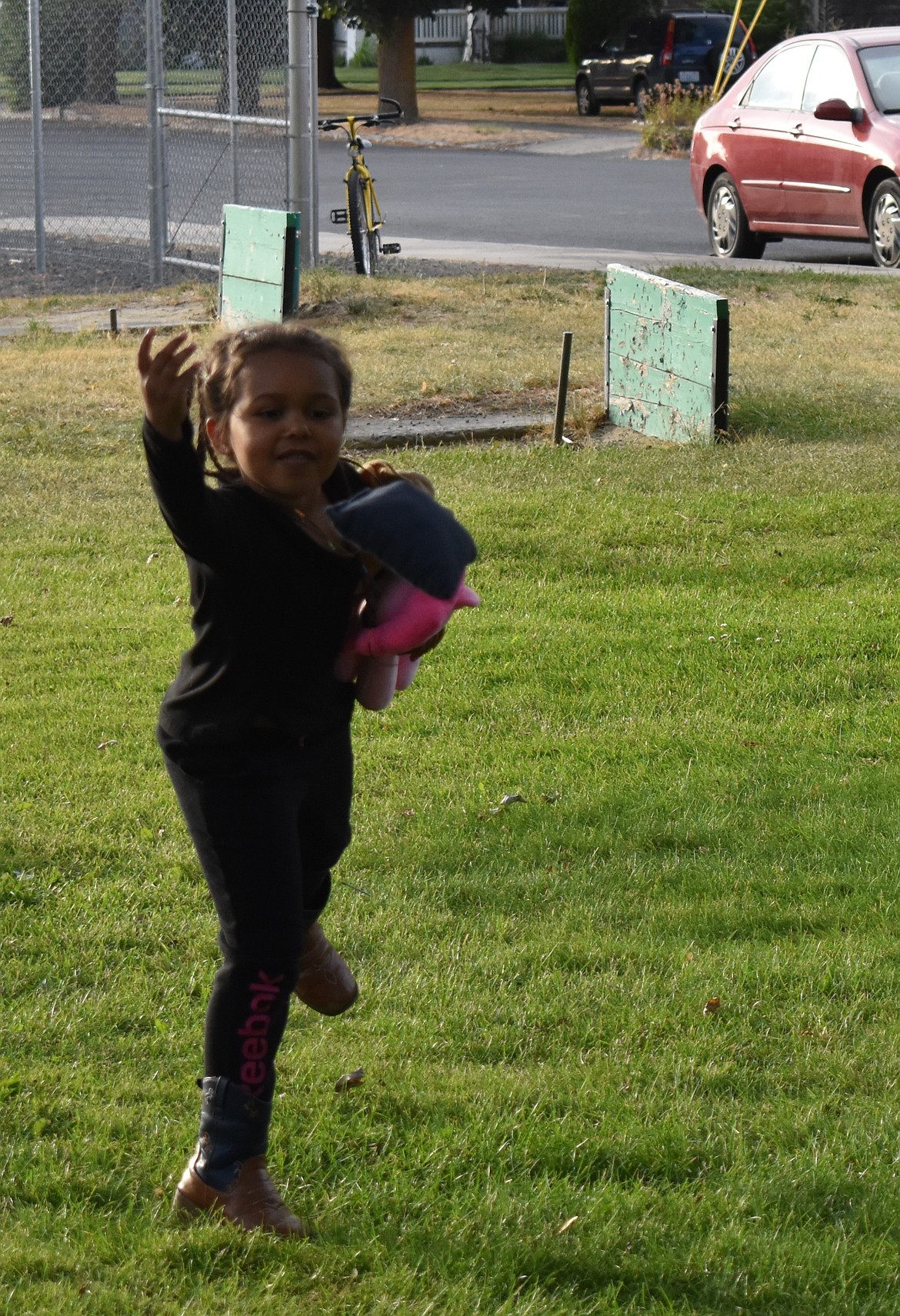 Shalom Malby, 6, throws a beanbag as she tries out a game of cornhole at Ritzville’s National Night Out. Shalom came with her uncle Joe Malby who said it was a great opportunity for his niece to get out and play with some friends.