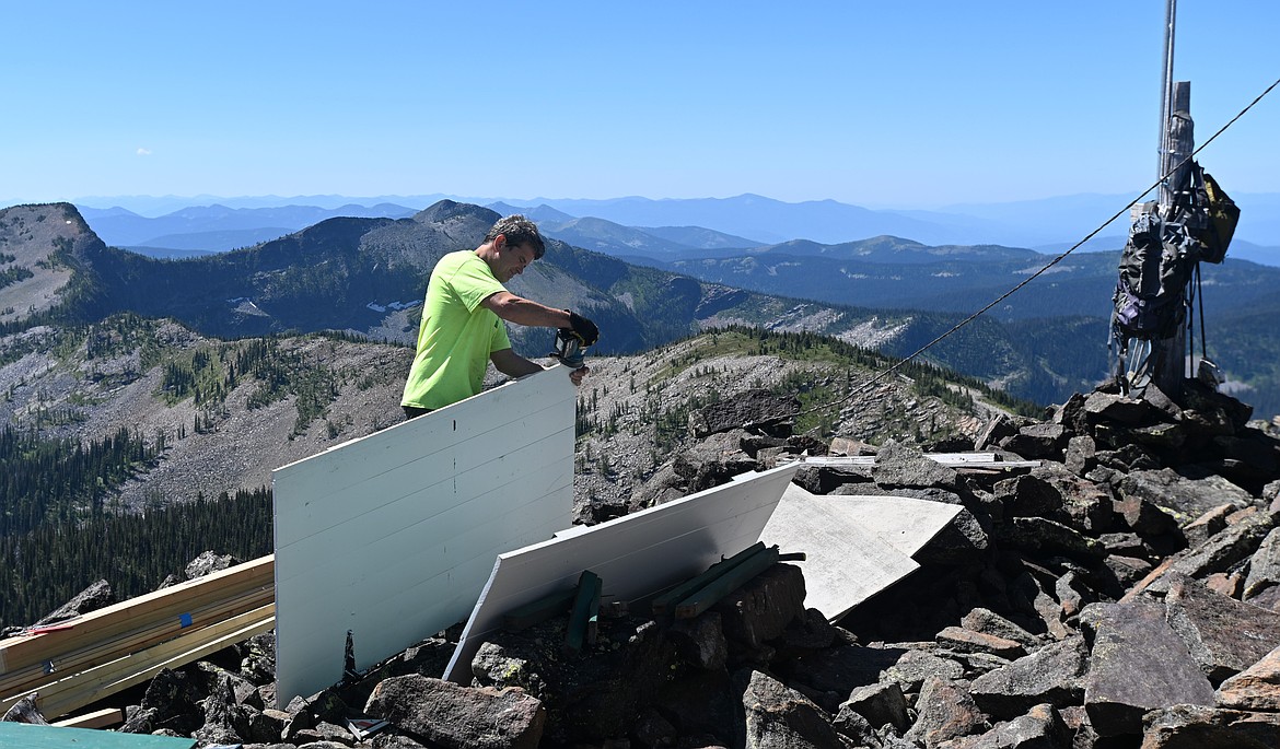 John Vardis sands a shutter from Northwest Peak Lookout on July 25, 2025. (Hailey Smalley/Daily Inter Lake)