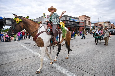 Kylee Oedekoven of Glacier View 4-H waves from atop her horse at the Northwest Montana Fair Parade on Friday, Aug. 8. (Casey Kreider/Daily Inter Lake)