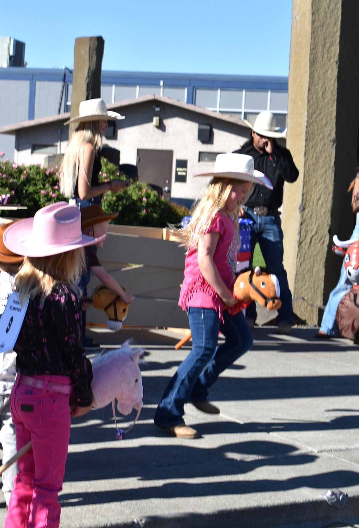 Claire Price, 9, of Moses Lake holds onto her bucking bronc at the Cowboy Breakfast Friday.