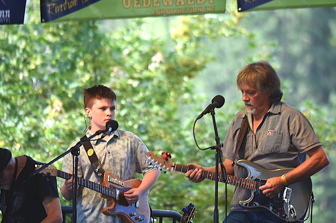 Kenny James Miller Band's Ken Sederdahl, right, and his grandson Chase perform together Friday, Aug. 8, 2025, at Libby's Riverfront Blues Festival. (Scott Shindledecker/The Western News)