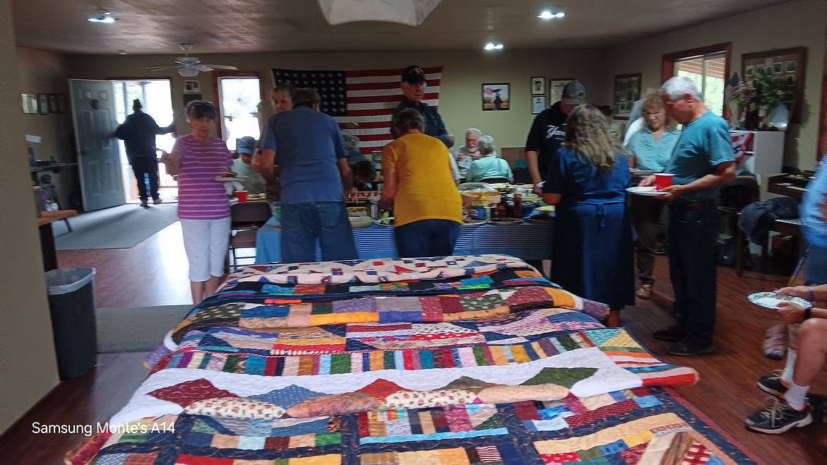About a dozen quilts from the Cabin Fever Quilters Guild were laid over the pool table in the American Legion Post 13 Headquarters on Monday for the 3 veterans receiving them to choose from. (Monte Turner/Mineral Independent)