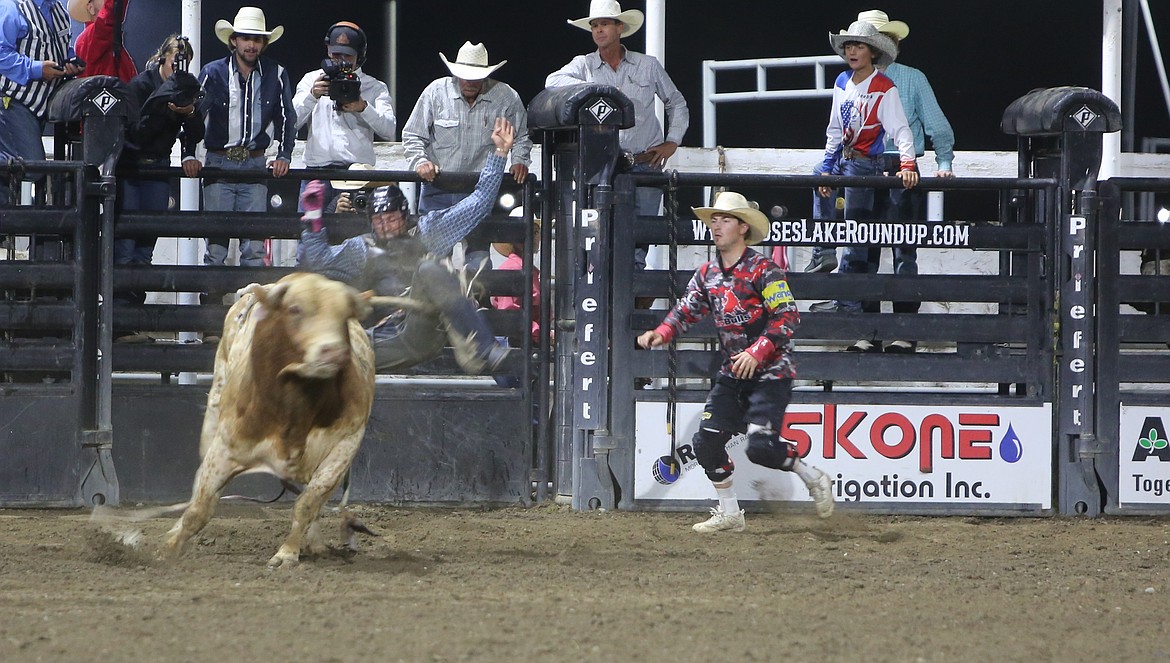 A bull rider in the Grant County Fair’s rodeo is thrown off the back end of a bull. Across three nights of rodeo action, 36 bull riders competed in the Moses Lake Roundup.
