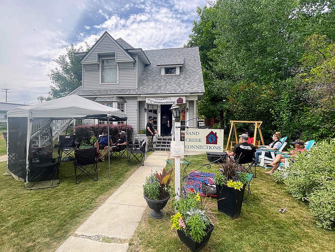 Sand Creek Connections' participants sit out front of the house on the 4th of July.