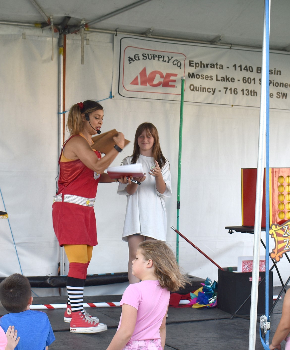 Zany Zoe does a magic trick with the help of an audience member at the Grant County Fair.
