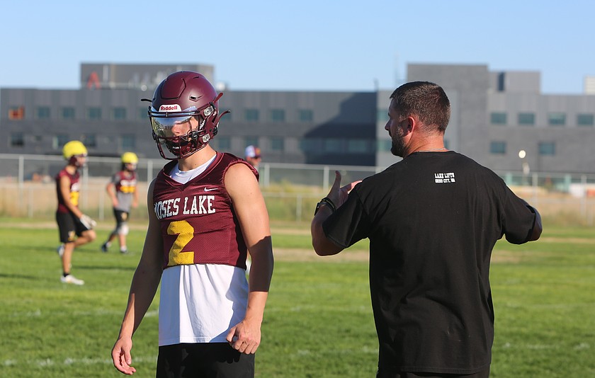 Mavs quarterback Brady Jay, left, listens to his coach Brett Jay, right, as they begin their first practice of the 2025 season. Brady is the Mavericks starting quarterback and will be attending Montana State starting in the fall of 2026.