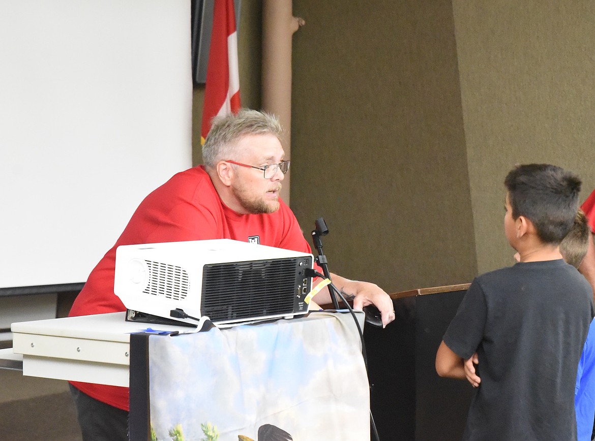 Historian and author Rich Aastad speaks to some young attendees at Libby Dam Saturday, Aug. 23, 2025, during the 50th anniversary ceremony. (Scott Shindledecker/The Western News)