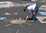 Imagination at work: Children cover church parking lot in chalk art
