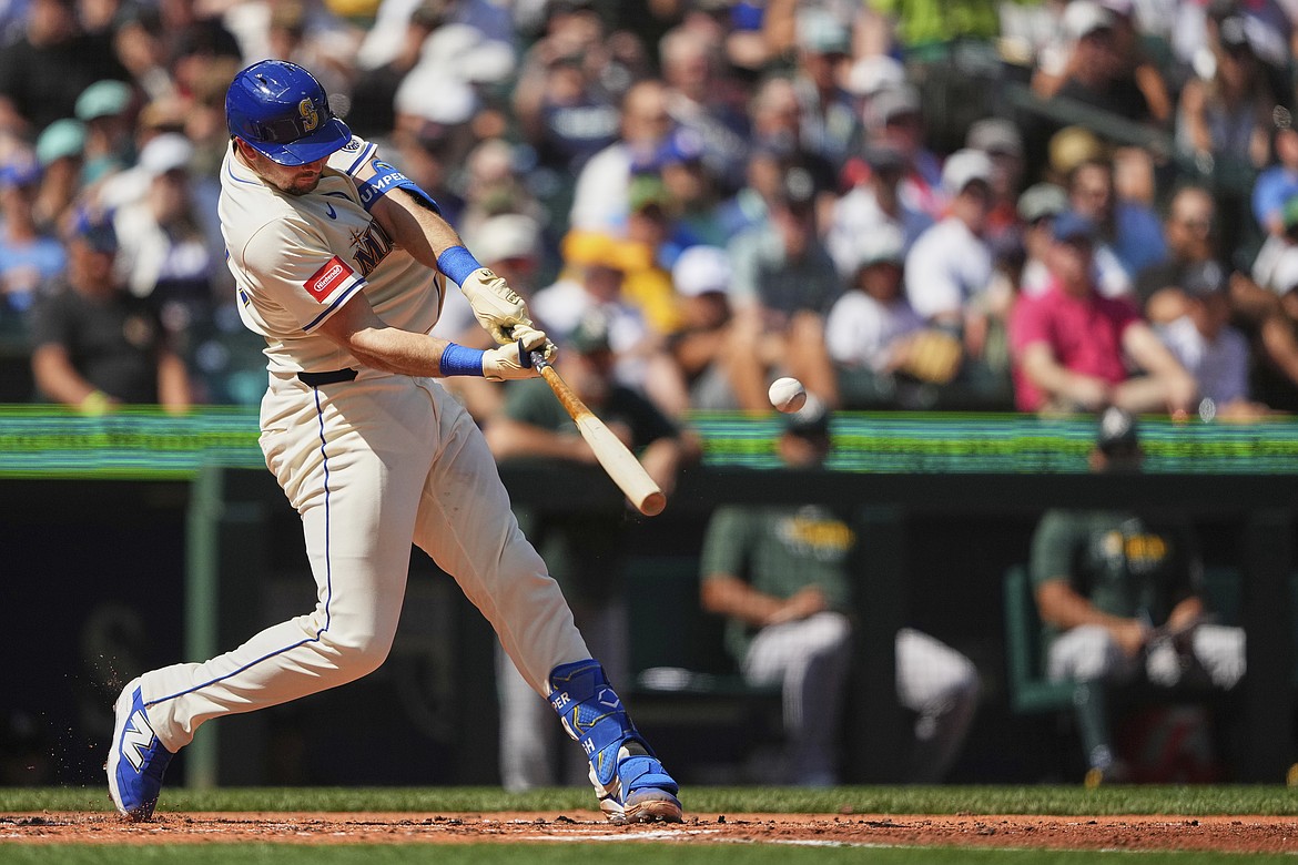 Seattle Mariners' Cal Raleigh hits a two-run home run to break the record for single-season home runs by a catcher at 49 during the second inning of a baseball game against the Athletics, Sunday, Aug. 24, 2025, in Seattle.