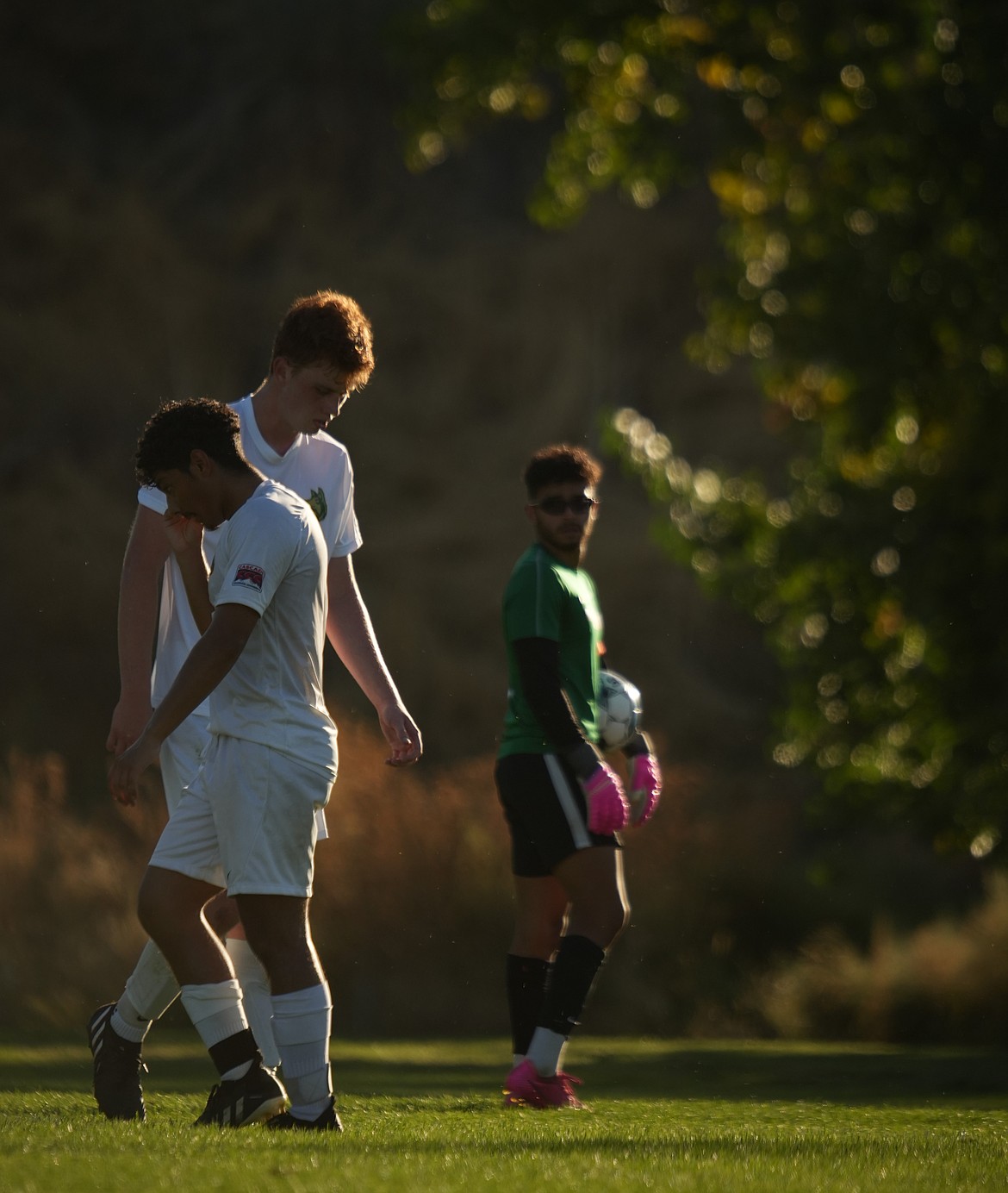 Israel Perez and his teammate cross paths waiting for the opposing team to bring the soccer ball back into play. Perez said he is pursuing a career in aviation and started his own business to help pay for college.