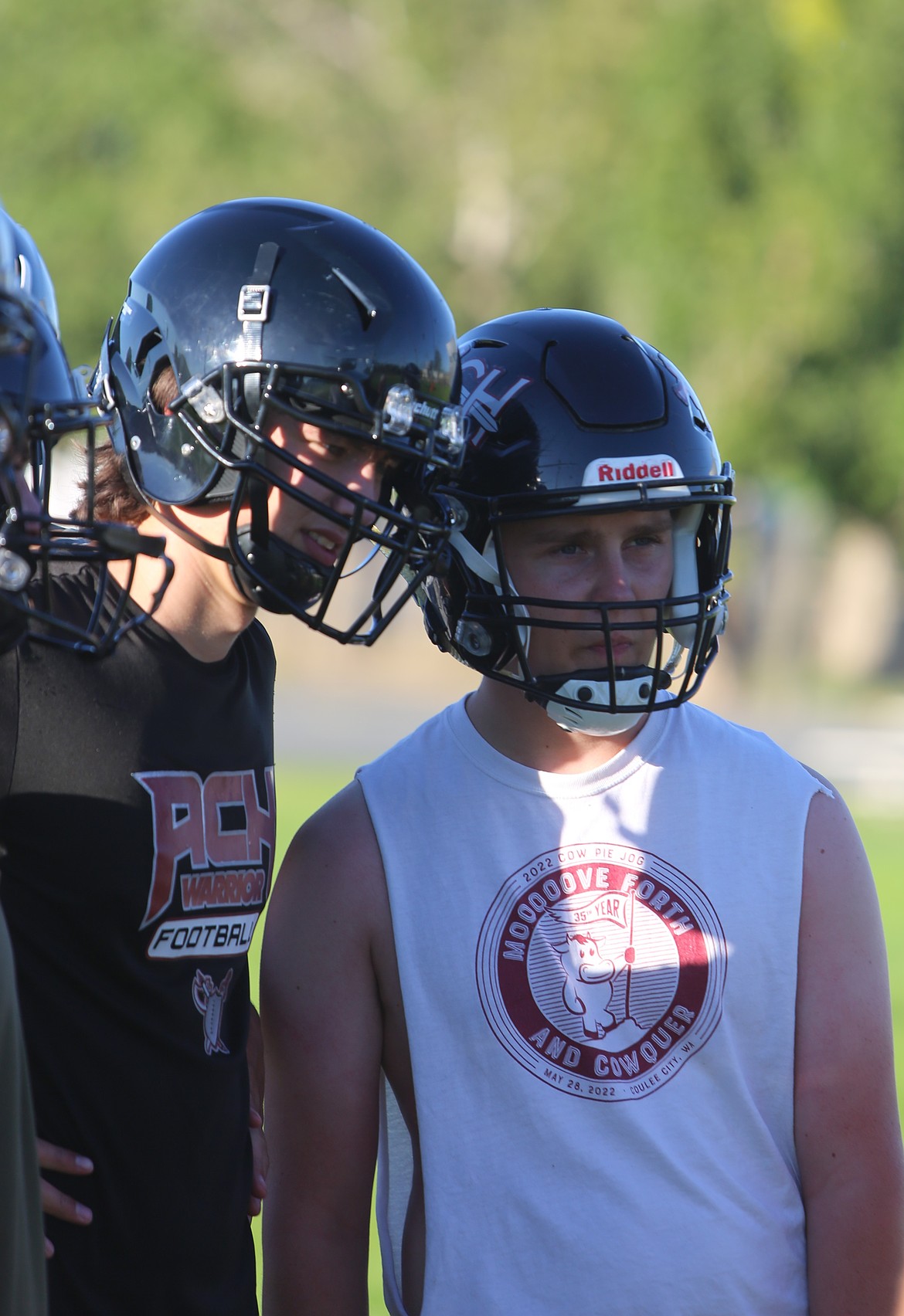 Two ACH Warriors football players watch drills during practice. The Warriors were one game shy of making the 1B state championship last season and are optimistic about returning this season.
