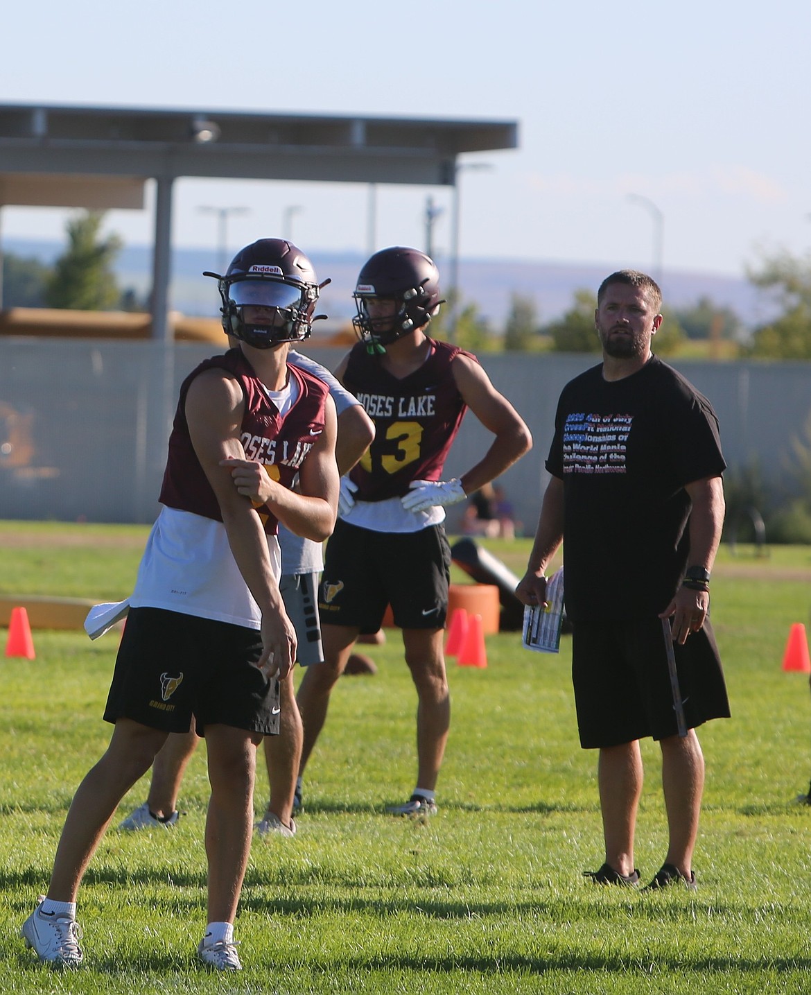 Mavericks quarterback Brady Jay takes some reps to throw at practice while Head Coach Brett Jay watches in the background. Brady said the team will take their season one week at a time.