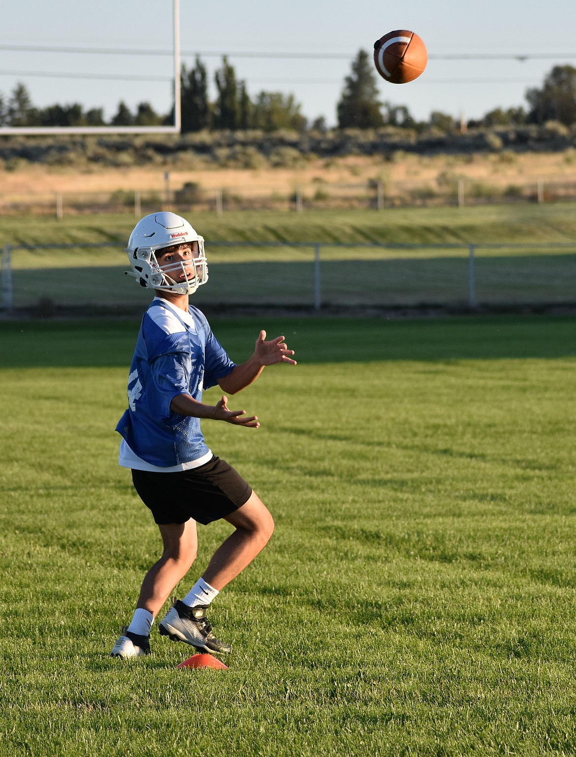 An Eagles player prepares to make a catch during a wide receiver drill at practice. Head Coach Garrett Devine said the team is working to make the state tournament after coming up two points short last season.