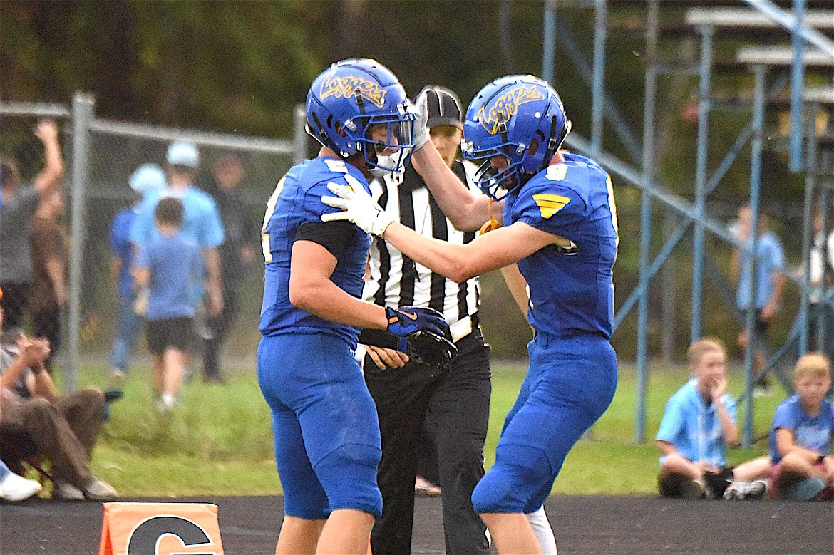 Libby Loggers receiver Isaac Lamere, left, and teammate Boe Miles celebrate Lamere's second TD catch of the first half during the game Friday, Aug. 29, 2025. (Scott Shindledecker/The Western News)