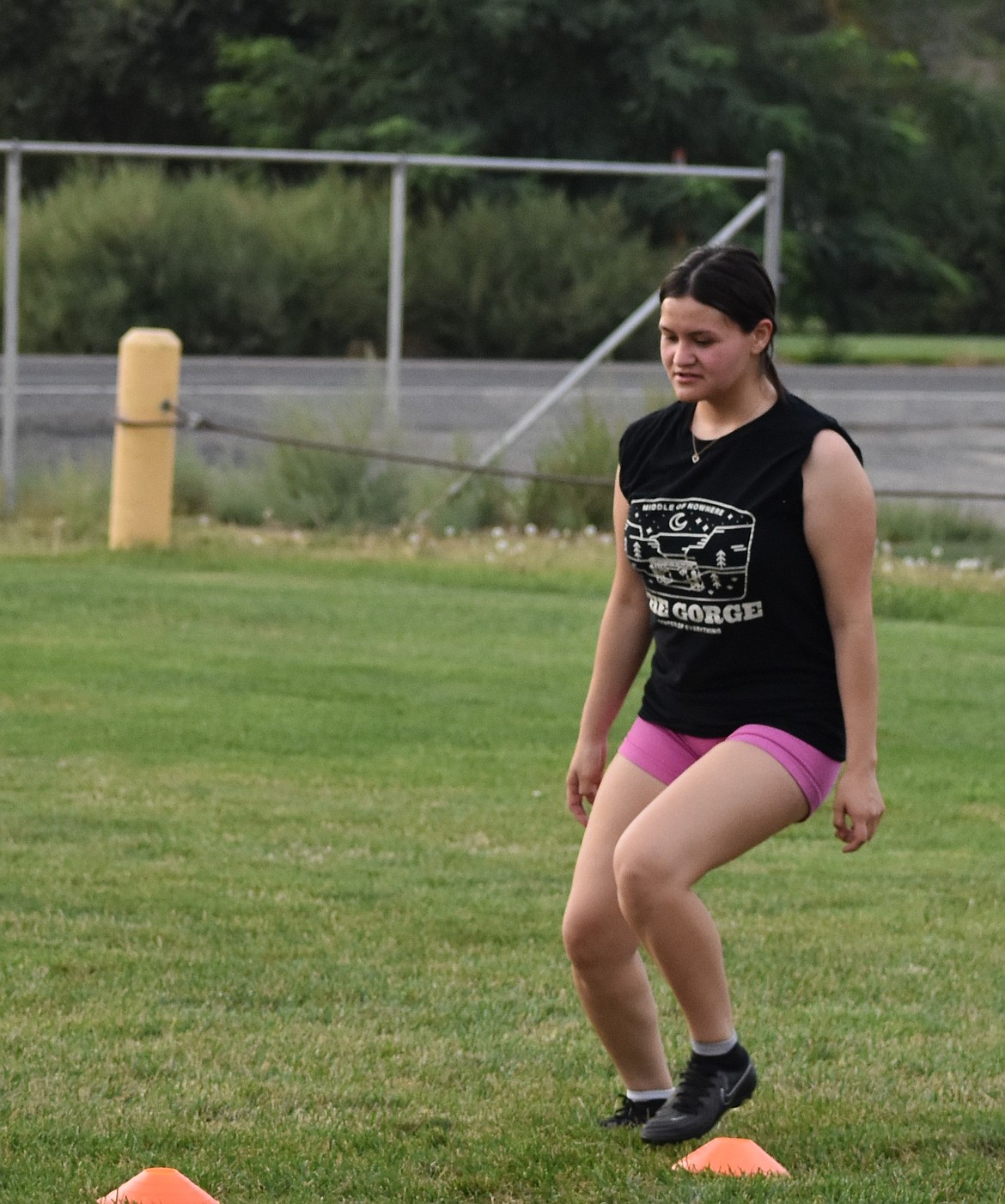 A player from the Warden soccer team works on an exercise where she cuts in between cones.