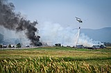 Crews work to extinguish ignited hay bales in grass fire west of Kalispell