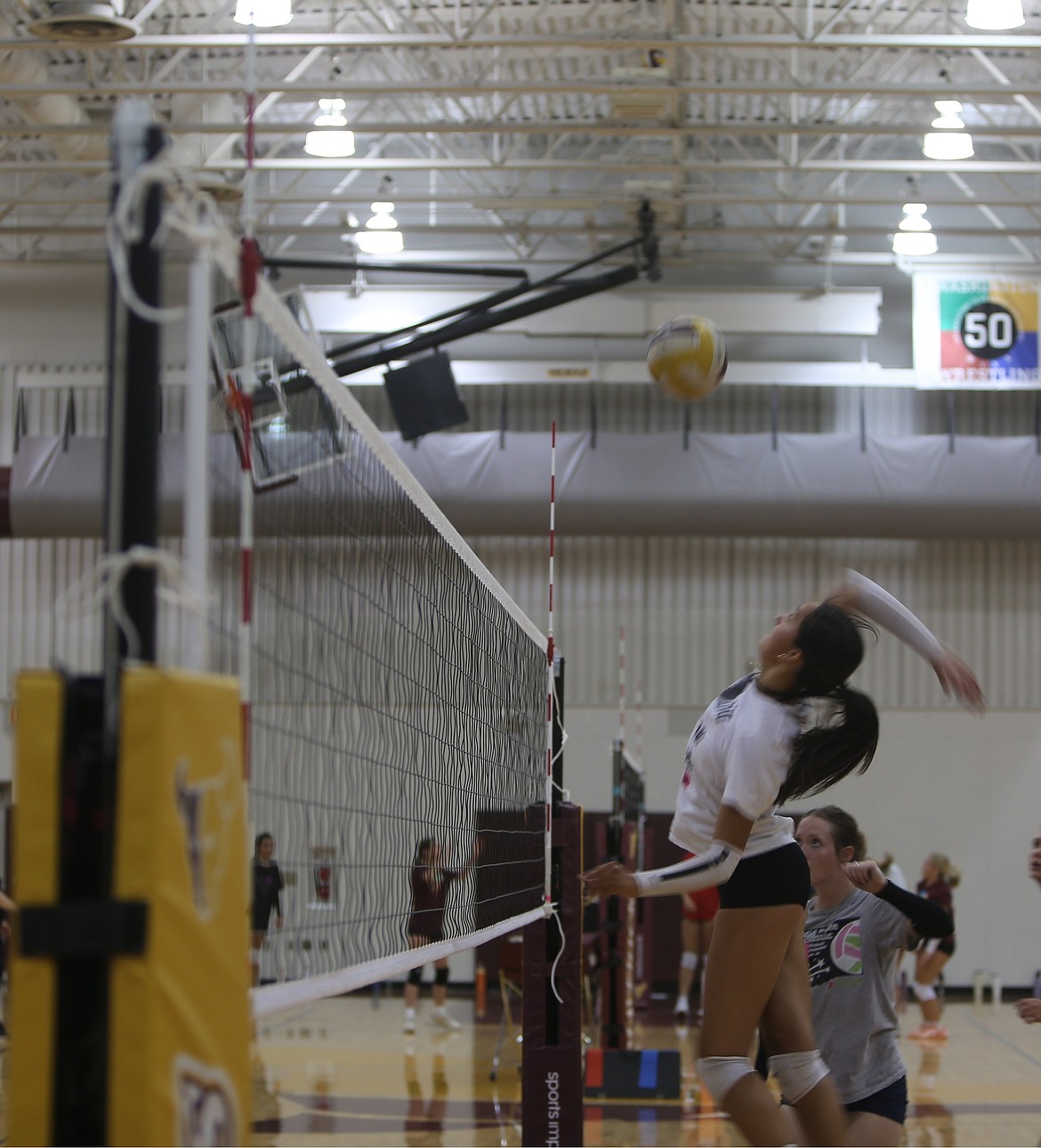 Lilliana Roylance leaps up to the net for a spike during the Mavs tryouts. Head Coach Krystal Trammell said her team appears to be very team-oriented this year and driven to win.