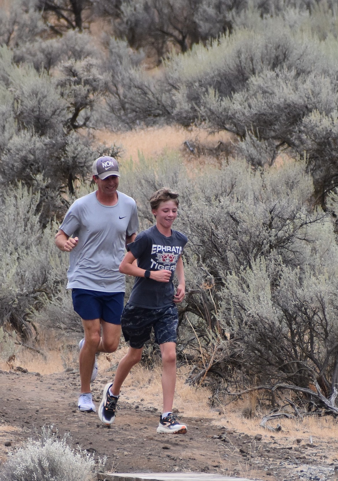 Tigers’ head coach Lyndsey Roberts runs with one of the student athletes as they finish their run around Beezley Hills. Roberts said this season will be a redemption season as they aim to make another push at the state tournament.