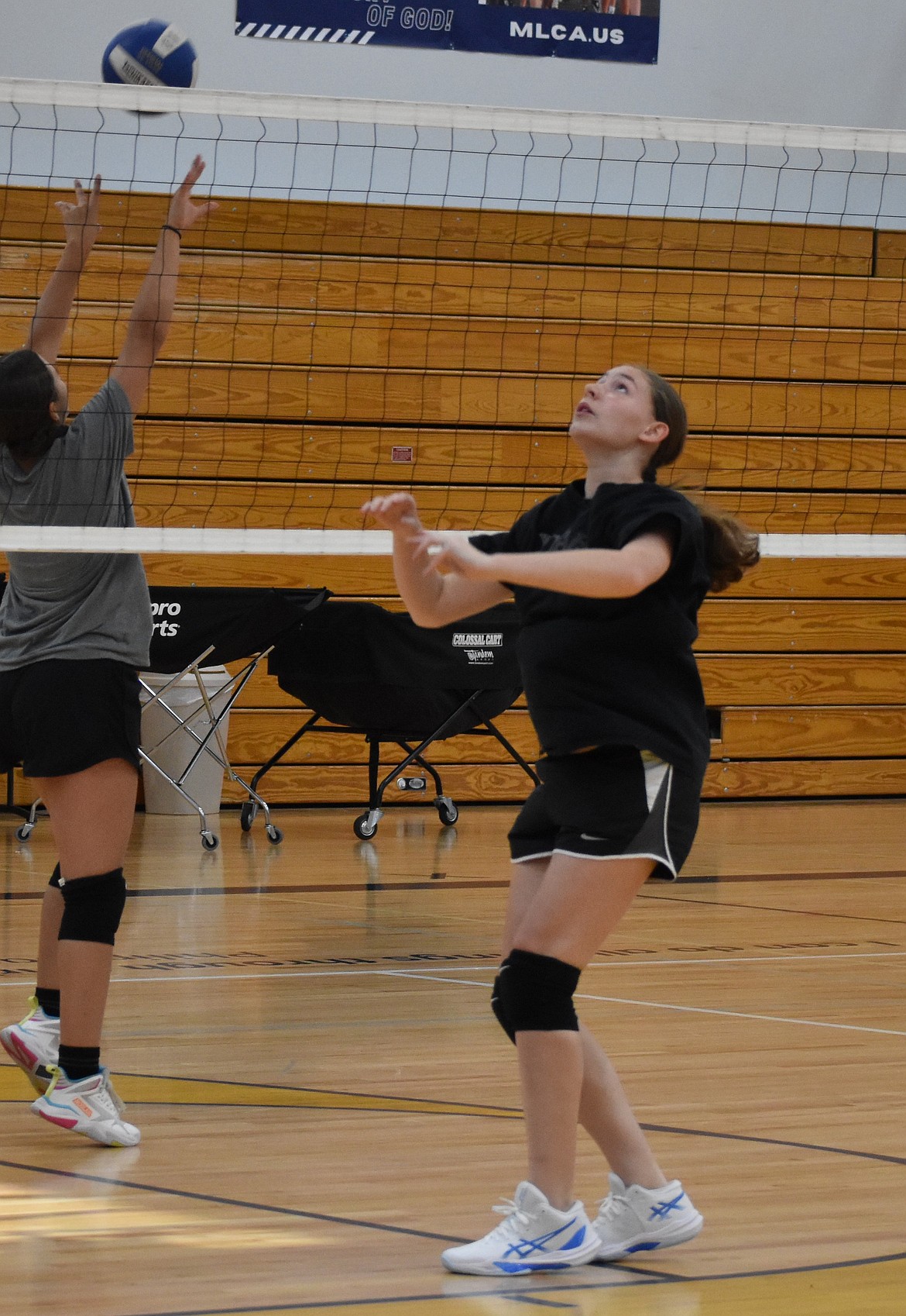 During a Lions volleyball practice, Emma Collins prepares to pass the ball back to her teammate to spike. This year is the fourth year back in the volleyball program for the Lions.