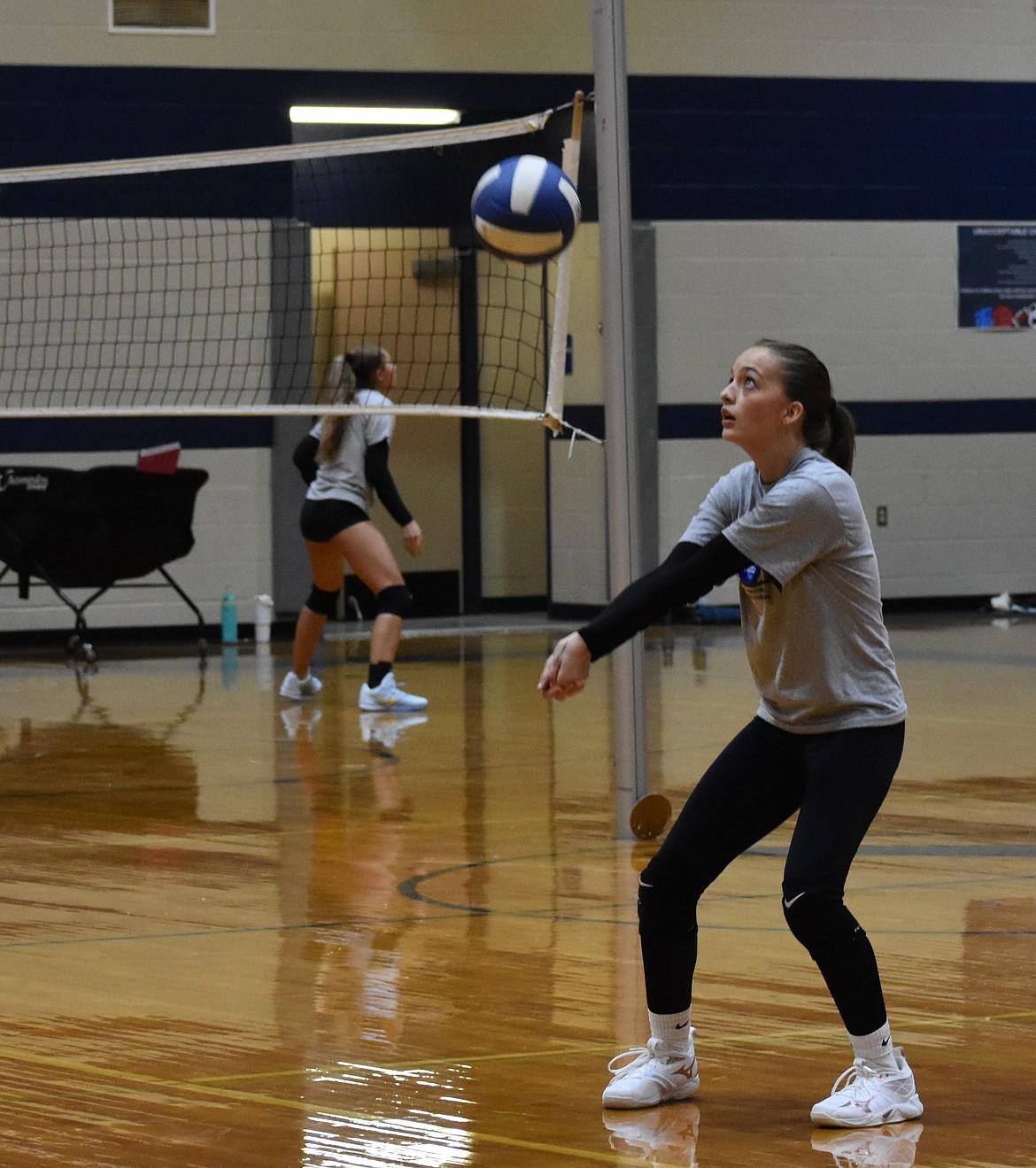 Olivia Noble hits the ball to her teammate during a warmup exercise at practice. Noble is one of the five freshman players on the team. Despite being younger, the freshman also come with both experience of the sport and with the team.