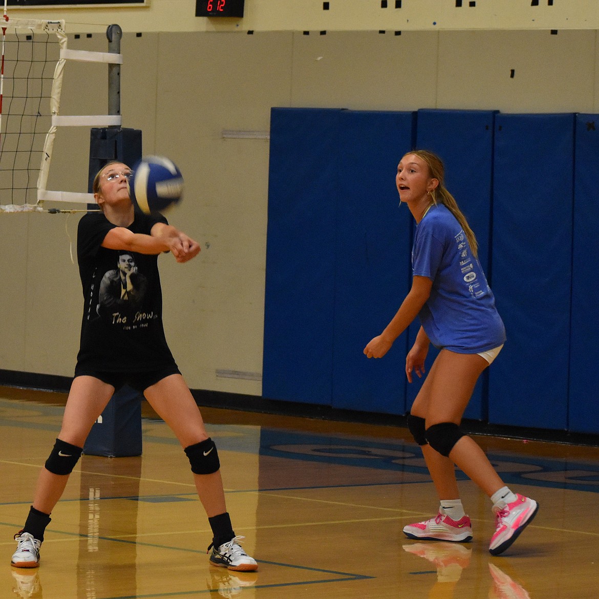 Two Cougars players working together during a practice match to get the ball back over the net. The coach and the seniors on the team said the team’s ability to work together throughout the season will be crucial to their success.