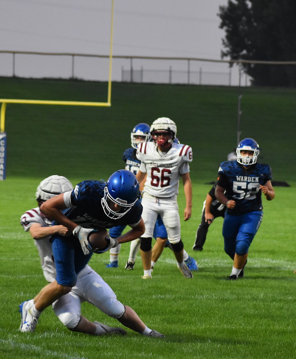 Tight End Hunter Golladay stretches out his arms for extra yardage while being tackled by a Medical Lake defender. The Cougars are preparing to return multiple starters for their week two matchup against Mossyrock.