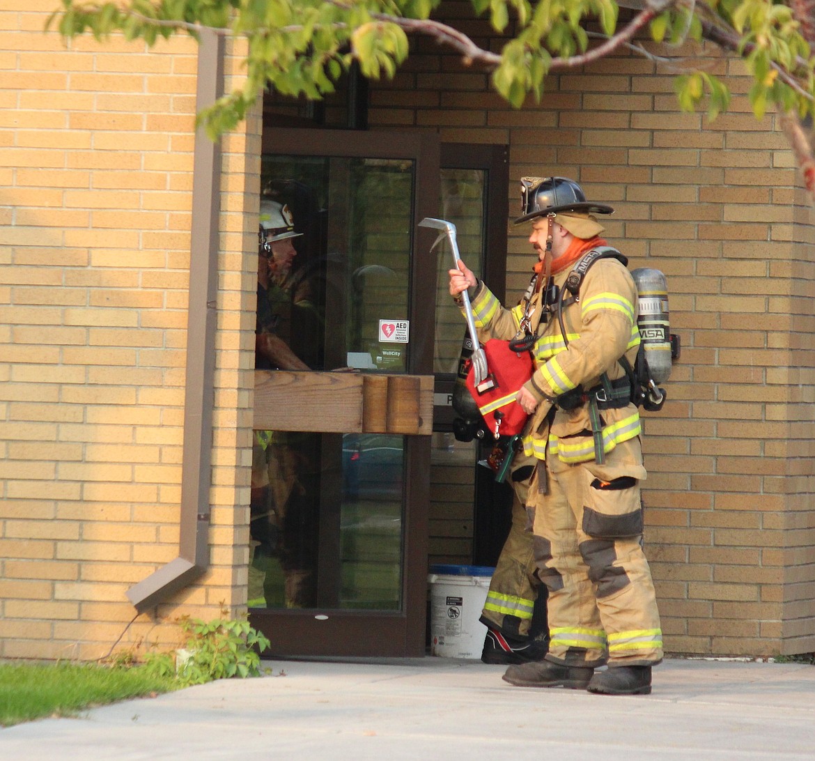 Moses Lake Fire Department firefighters check the Moses Lake Civic Center Annex after a power interruption triggered fire alarms in city buliding and the Moses Lake Public Library Friday afternoon.