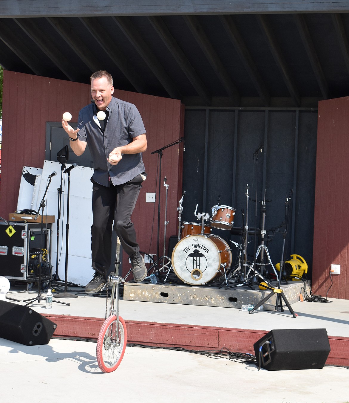Juggler Paul Isaak keeps three balls aloft while teetering on a unicycle at the Othello Fair Thursday. Isaak has been juggling professionally for more than 35 years, he said.
