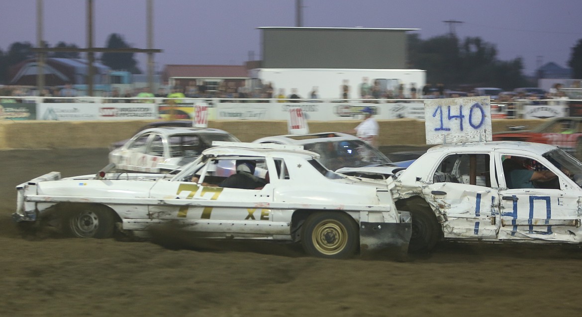 Jake Sligar (77) drives in reverse around the dirt track after being spun out in a heat race at the Othello Demolition Derby.