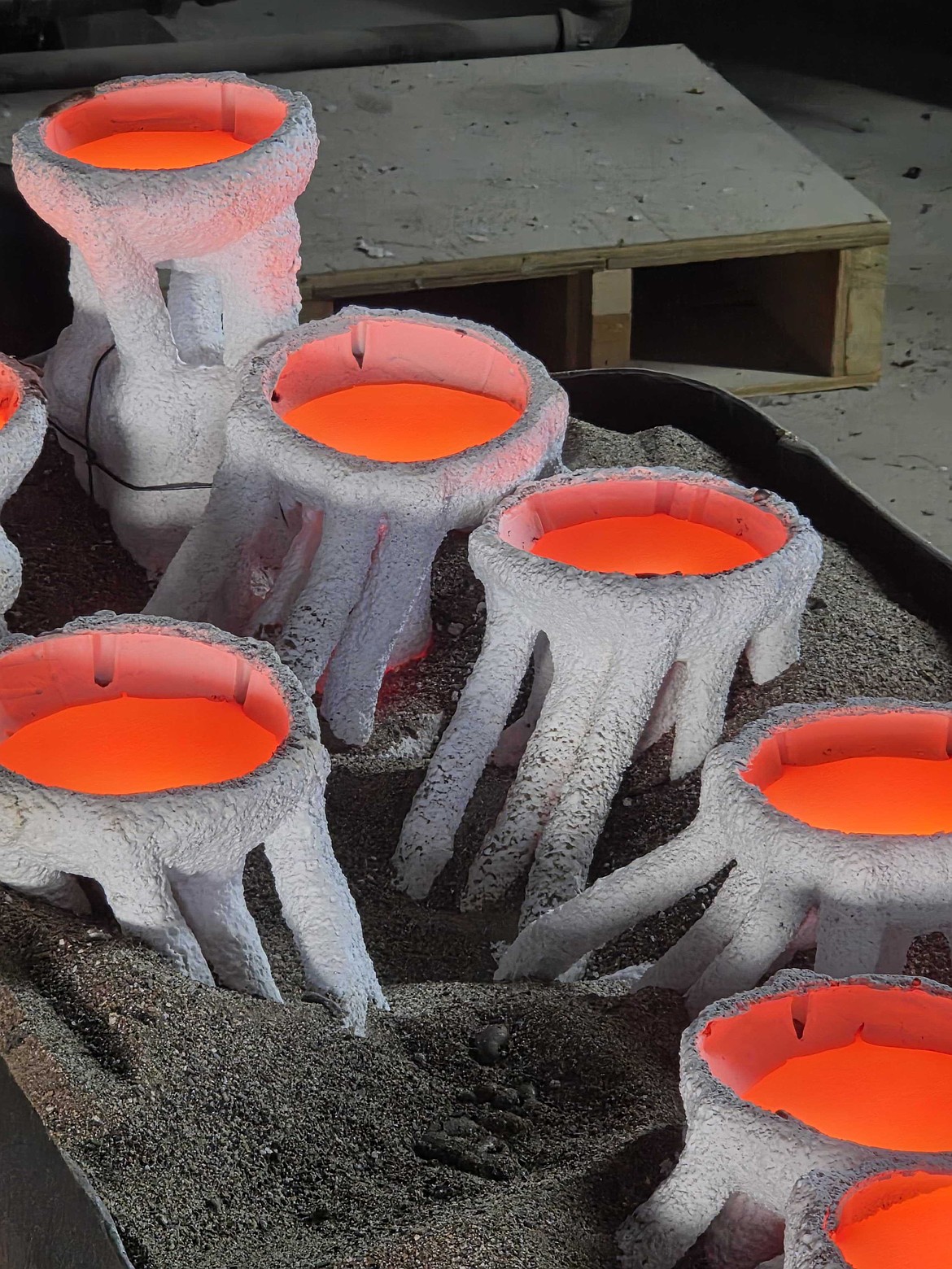 Molten bronze in molds at Kalispell Art Foundry. (Photo courtesy of Amanda Markel)