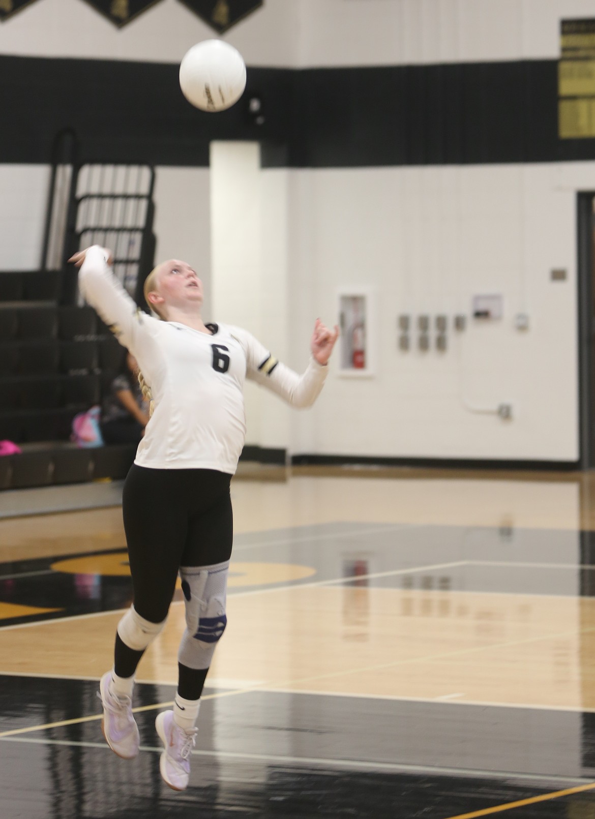 Knights’ Ava Lawrence leaps to serve the ball against Cashmere on Thursday. The Knights improved their scoring in each set. Head Coach Lisa Lawrence said her team showed improvement against Cashmere despite the loss.