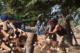 Volunteers chop firewood for ElderHelp of North Idaho to deliver to seniors