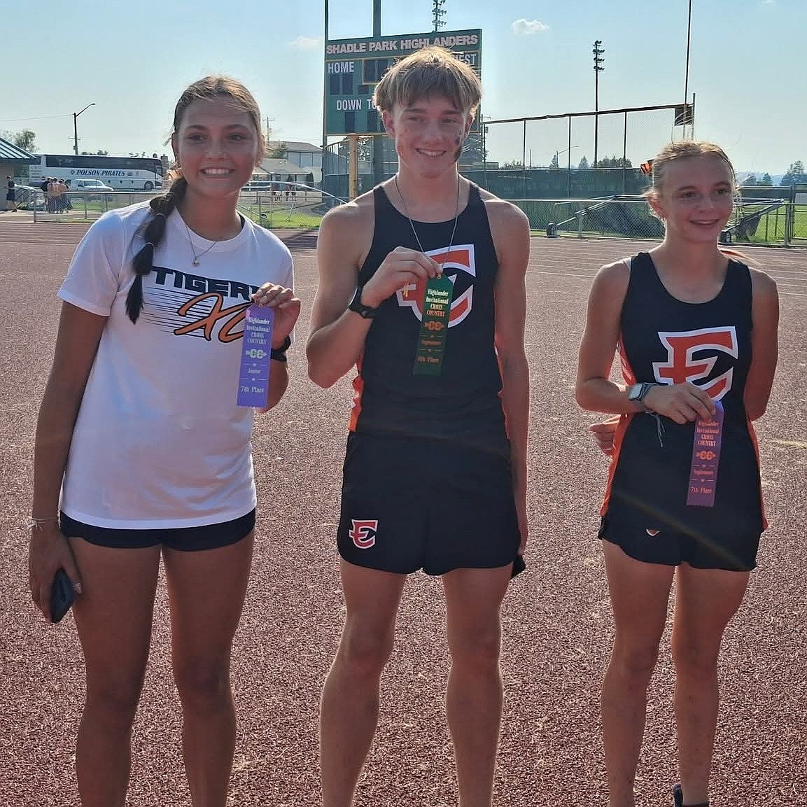 Tigers junior Hannah Malone and sophomores Caleb Fitts and Savannah Harper stand together after each earned seventh in their individual races. The Tigers’ head coach Lyndsy Roberts said this meet was a great opportunity for the athletes to run in a large event.