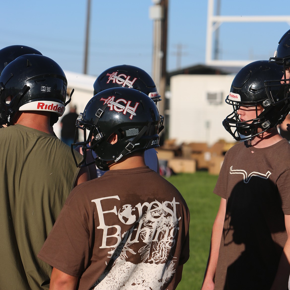 The ACH Warriors huddle up during drills at practice. As a team the Warriors had 300 yards rushing and 151 passing.