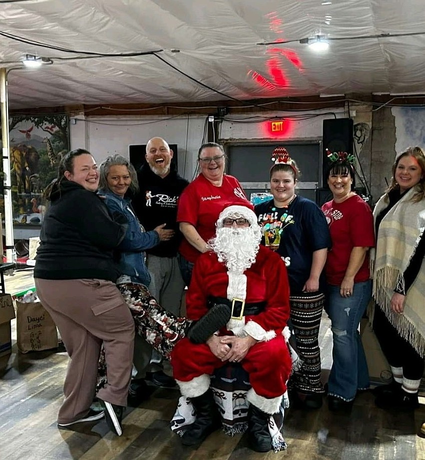 Members of the Moms Helping Moms group gather to take a photo with Santa. Austin said they do a meet-and-greet with Santa every year during the holiday season.
