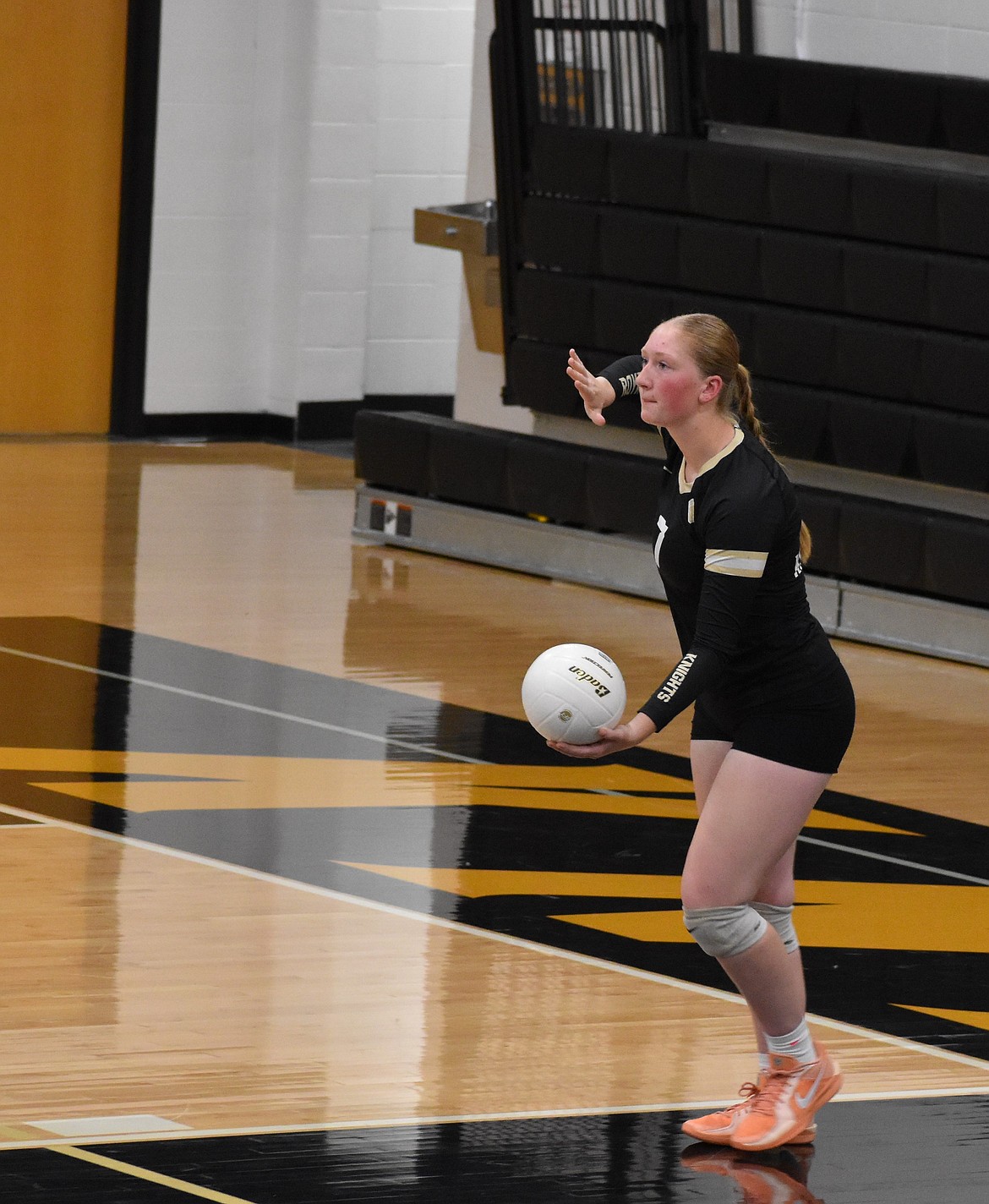 Avarie Hill, a senior for the Knights, prepares to serve the ball during their game against Naches Valley. The Knights took the lead early in the first two sets, with Naches Valley coming closer in the third.