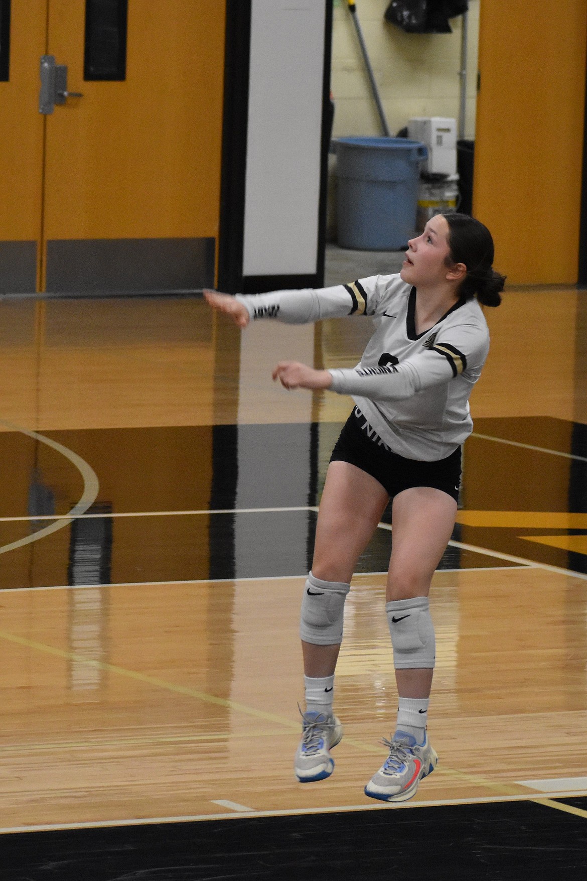 The Knights’ junior player Heaven Parker serves the ball to her opponent Tuesday evening. Parker said she felt like she performed well on Tuesday and any time she made a mistake her teammates were there to back her up.