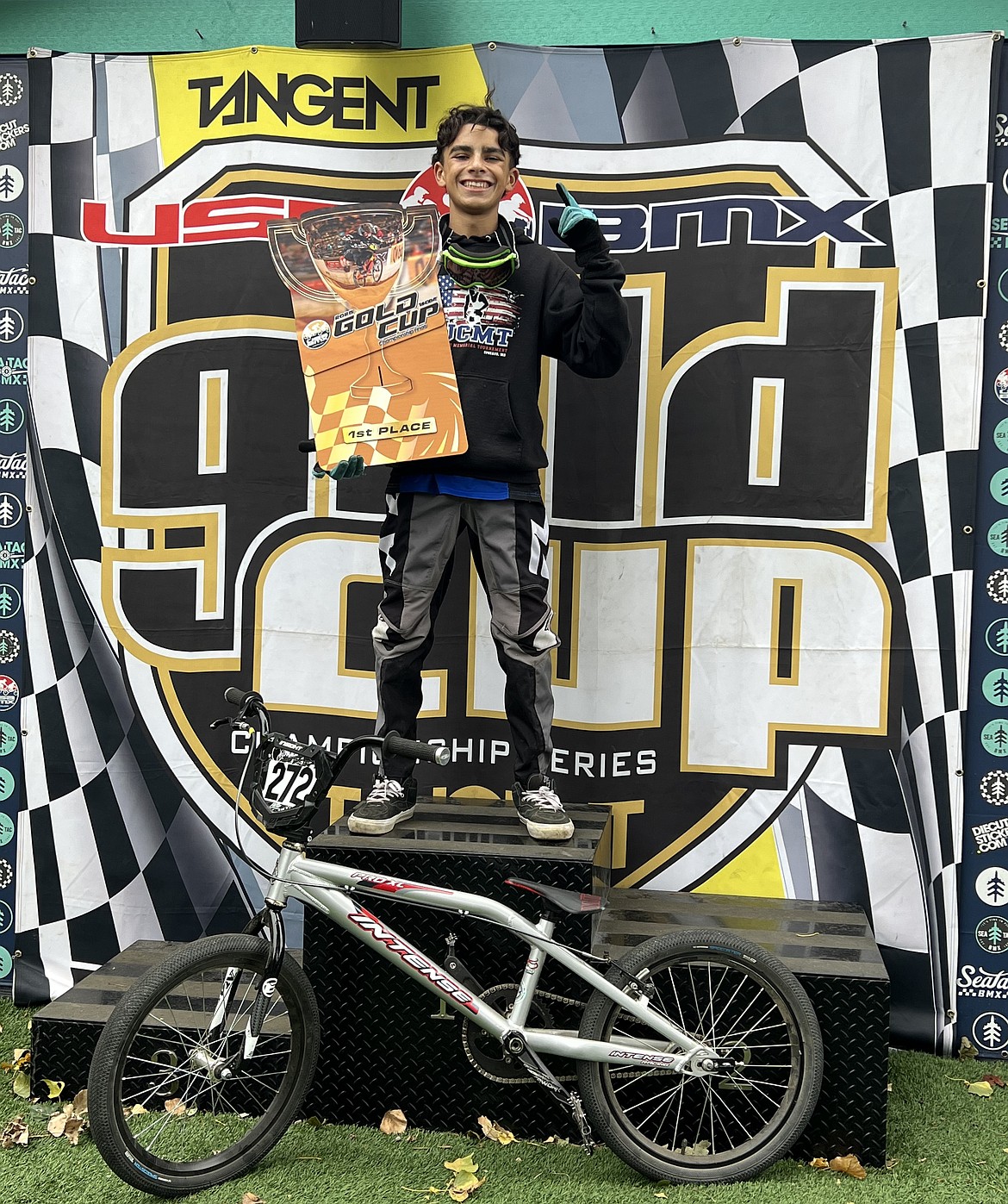 Logan Vela standing on a podium after finishing first in the novice group of the northwest Gold Cup Final in Seattle. Vela said he felt relief after winning his race.