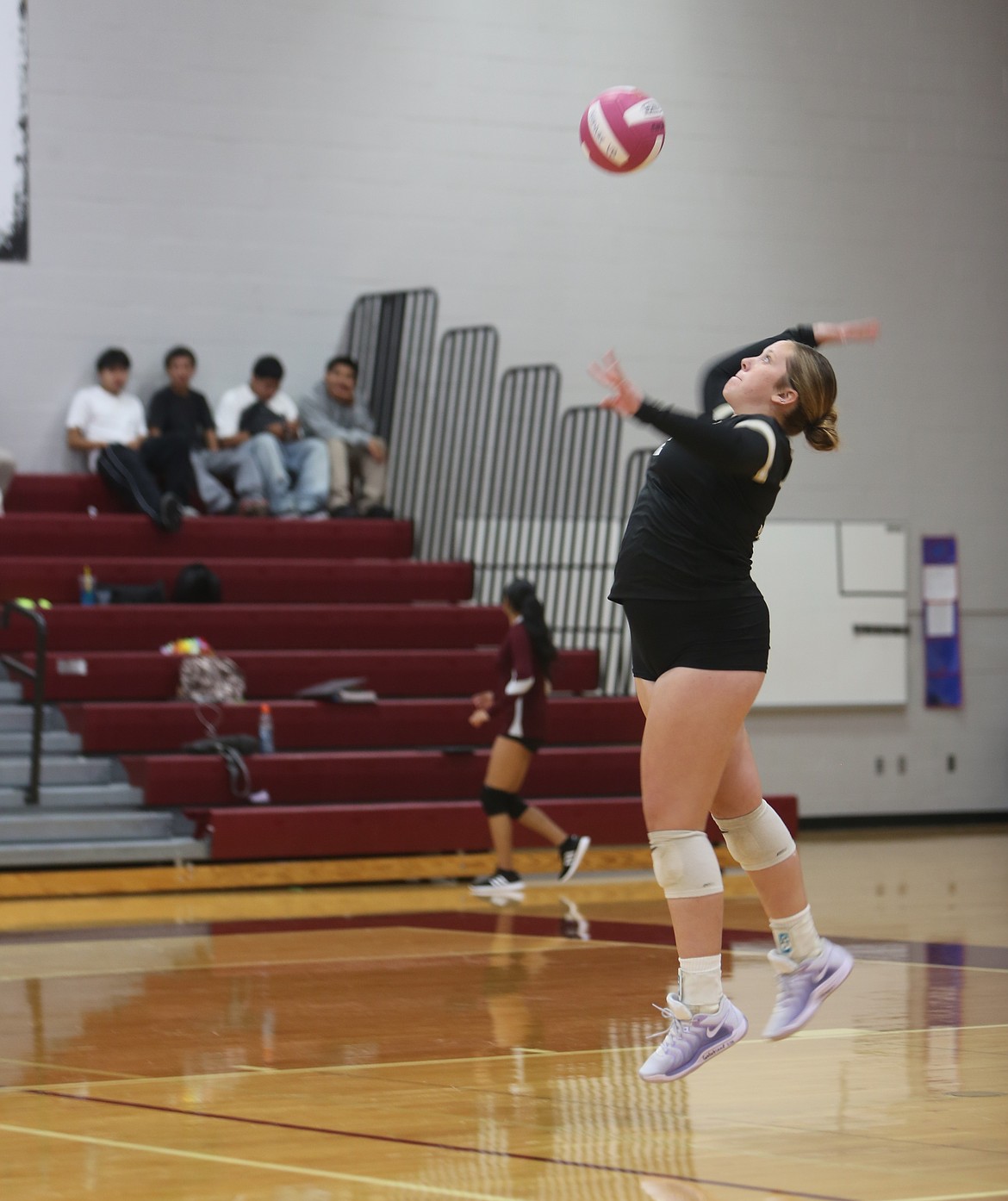Michelle Woodward (12) of the Knights serves the ball to the Wahluke Warriors. The Knights defeated the Warriors 3-0 on Thursday.