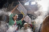 Marchers gather in worldwide protest of financial institutions 'profiting off the climate crisis'