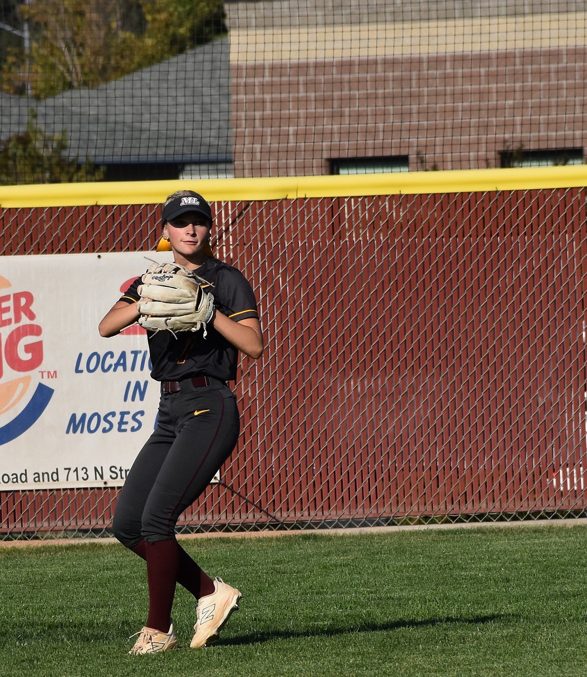 Mavs senior Lila Johnson catches a hit in the outfield for an out against Eisenhower. Head coach Mike Hofheins said the team did a great job on defense through both games.