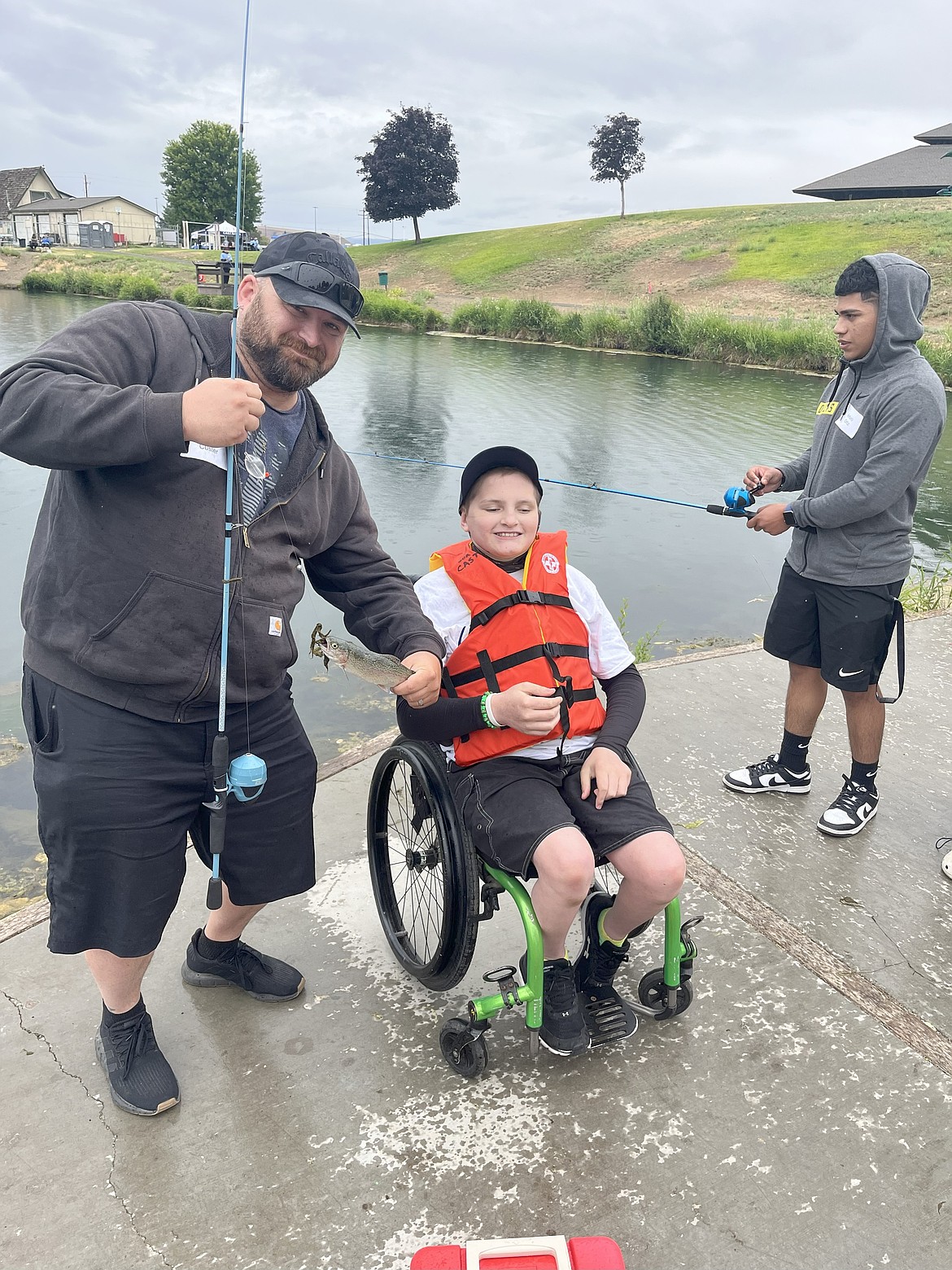 A fishing duo poses for a photo during one of the CAST events earlier this year. CAST manager Melissa McCalmant said if the events take place on a boat, organizers will ensure there are boats that are wheelchair accessible available.