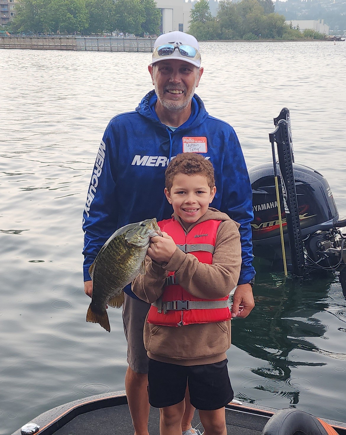 A young angler holds up a smallmouth bass that he caught alongside his boat captain. There are currently four regular CAST events around Washington with more added this year or in the works for the future.