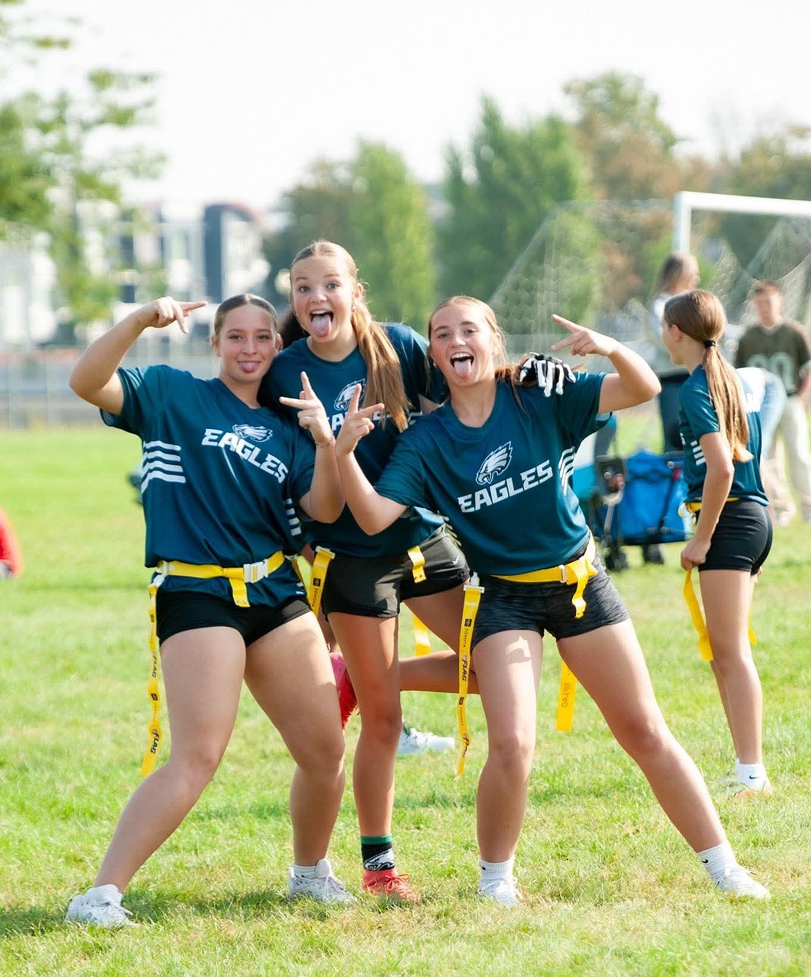 Grid Kids girls, Sohpia LaGrave, Carlee Reffett and Josie Carlstrom pose for a photo following one of their games. With the addition of NFL Flag, Grid Kids saw enough signups to have six girls teams put together and had around 55 girls in total.