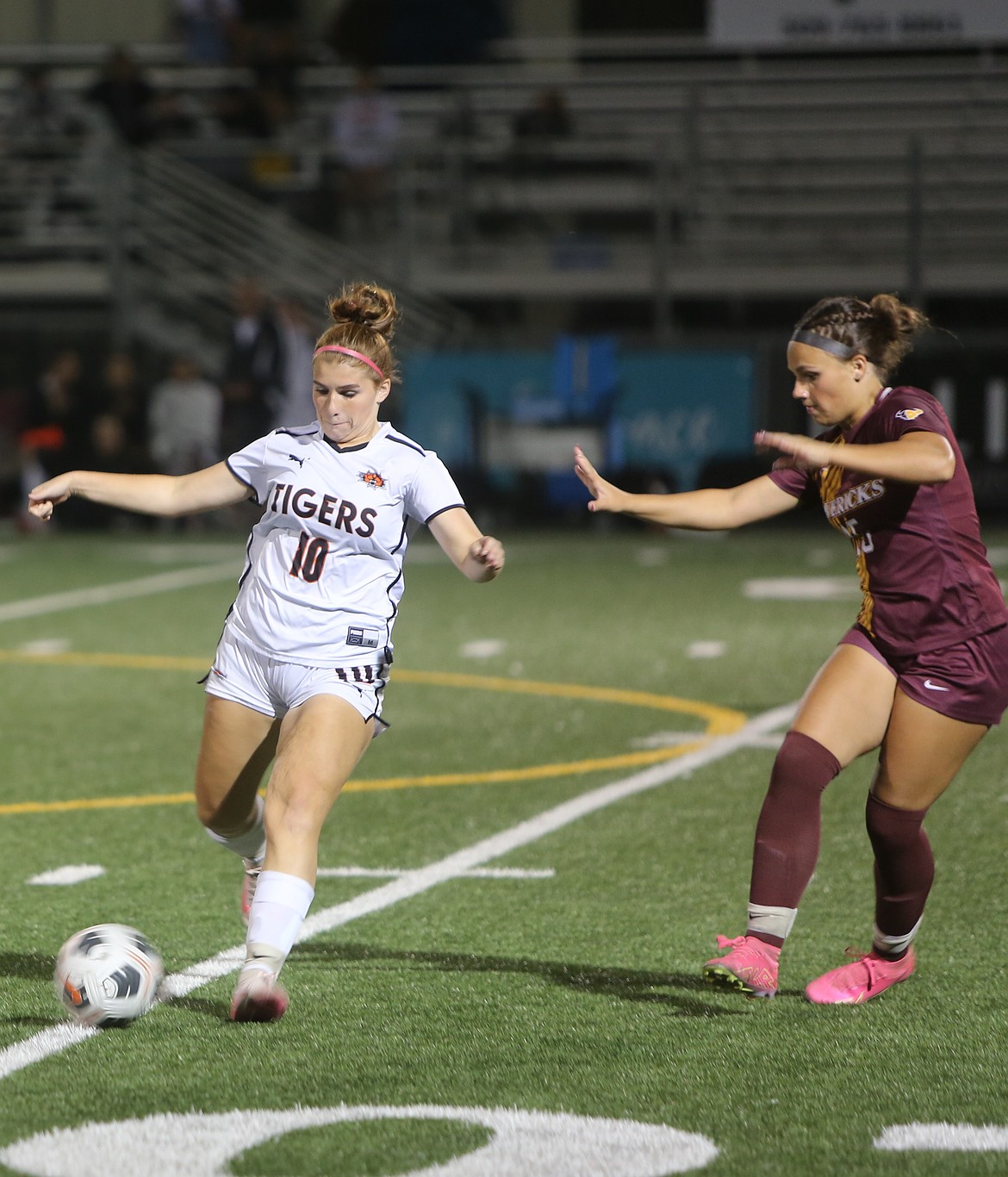 The Tigers' Brooklynn Sieverkropp (10) maintains control of the ball while Cayla Throneberry (15) applies the defensive pressure. Tigers Head Coach Gary Klepec said his players did a good job of playing physically with the Mavericks.
