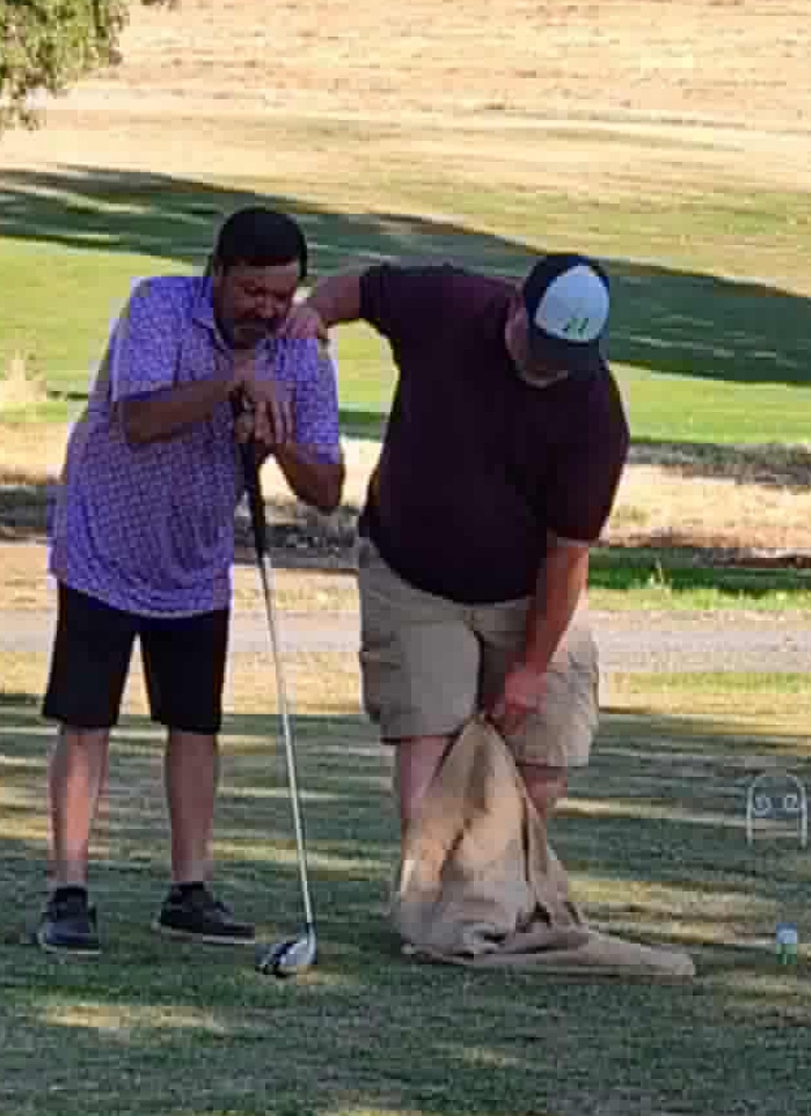 Two golfers work through a challenge in the “Dude! Where’s my Cart!?” charity golf tournament. Event organizer Karisti Cox said the tournament is aimed to be a fun and educational experience for golfers.