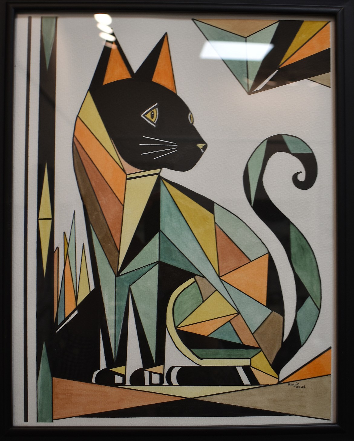Angela Hagerty’s watercolor “Cat of Many Colors” fills in the curved lines with sharp, angular mosaic tiles.