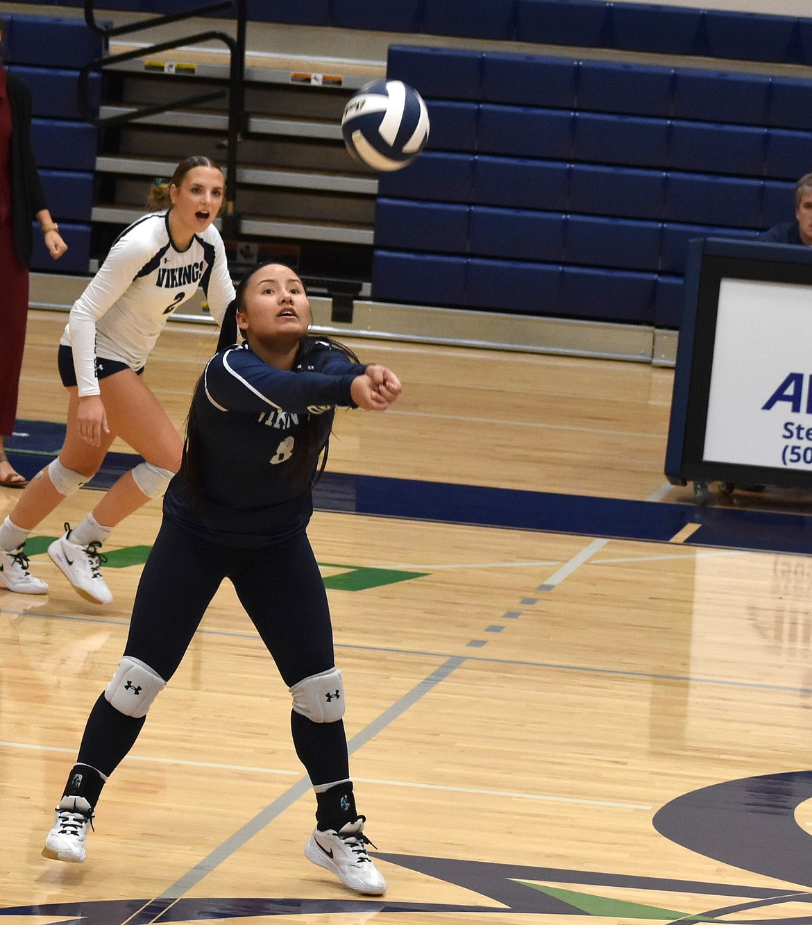 Vikings’ player Jah Chong sets the ball up for one of her teammates during Friday’s game. The Vikings are going to put an effort on increasing their overall speed moving forward, their coach said.